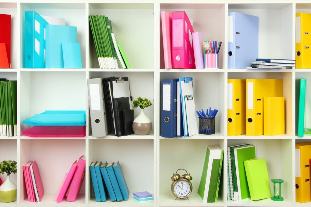 bright coloured folders on white shelving unit