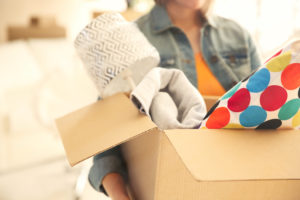 A woman carrying a box of clutter